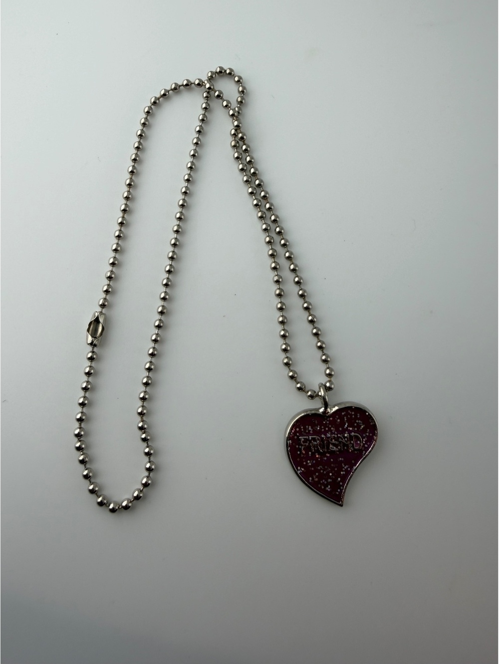 Silver tone ball chain necklace with pink heart pendant